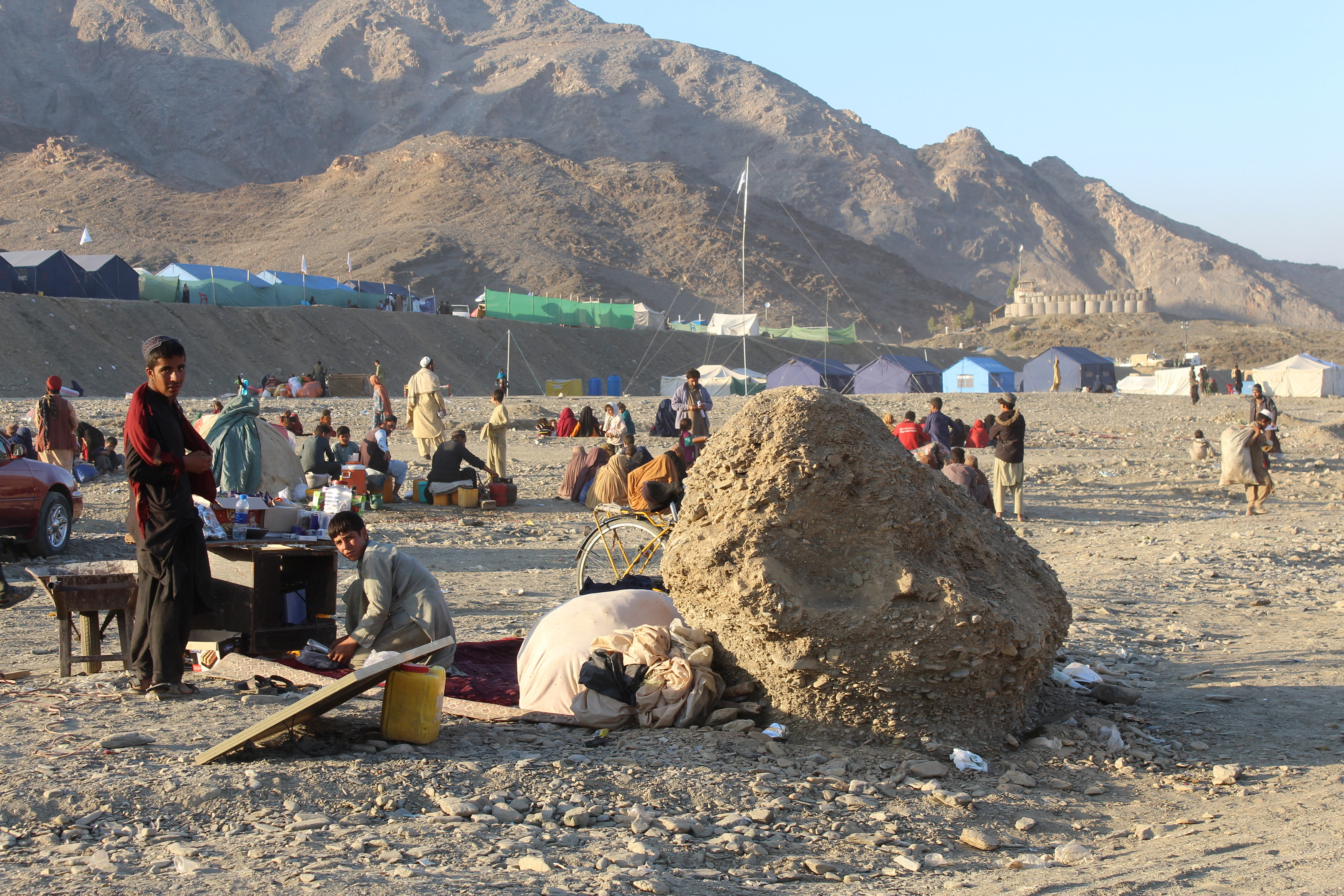 Afghan nationals rest at a camp after returning from Pakistan at Torkham border crossing