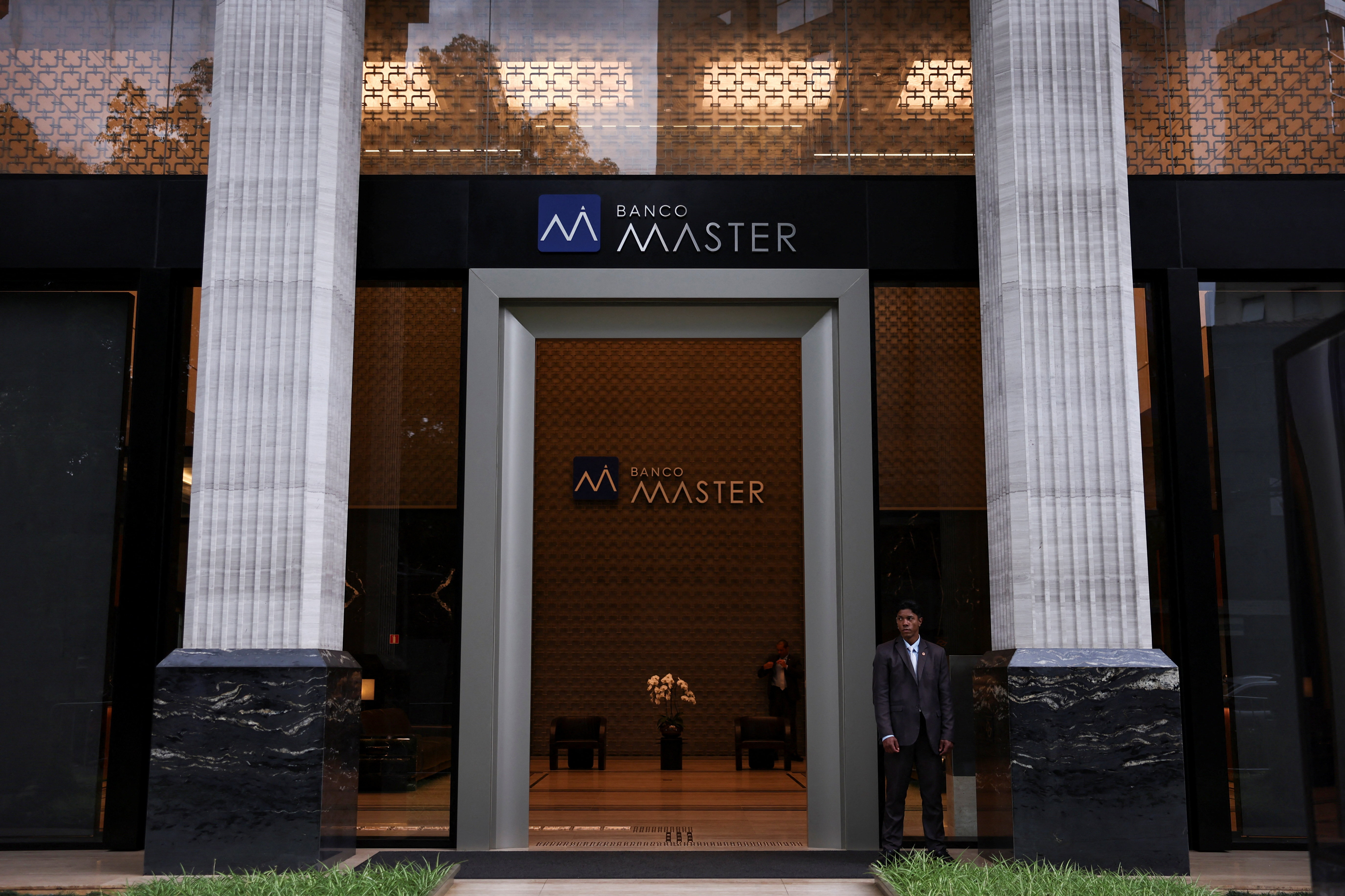 A security guard stands outside Bank Master (Banco Master), following the arrest of the controlling shareholder of lender Banco Master, businessman Daniel Vorcaro, in Sao Paulo