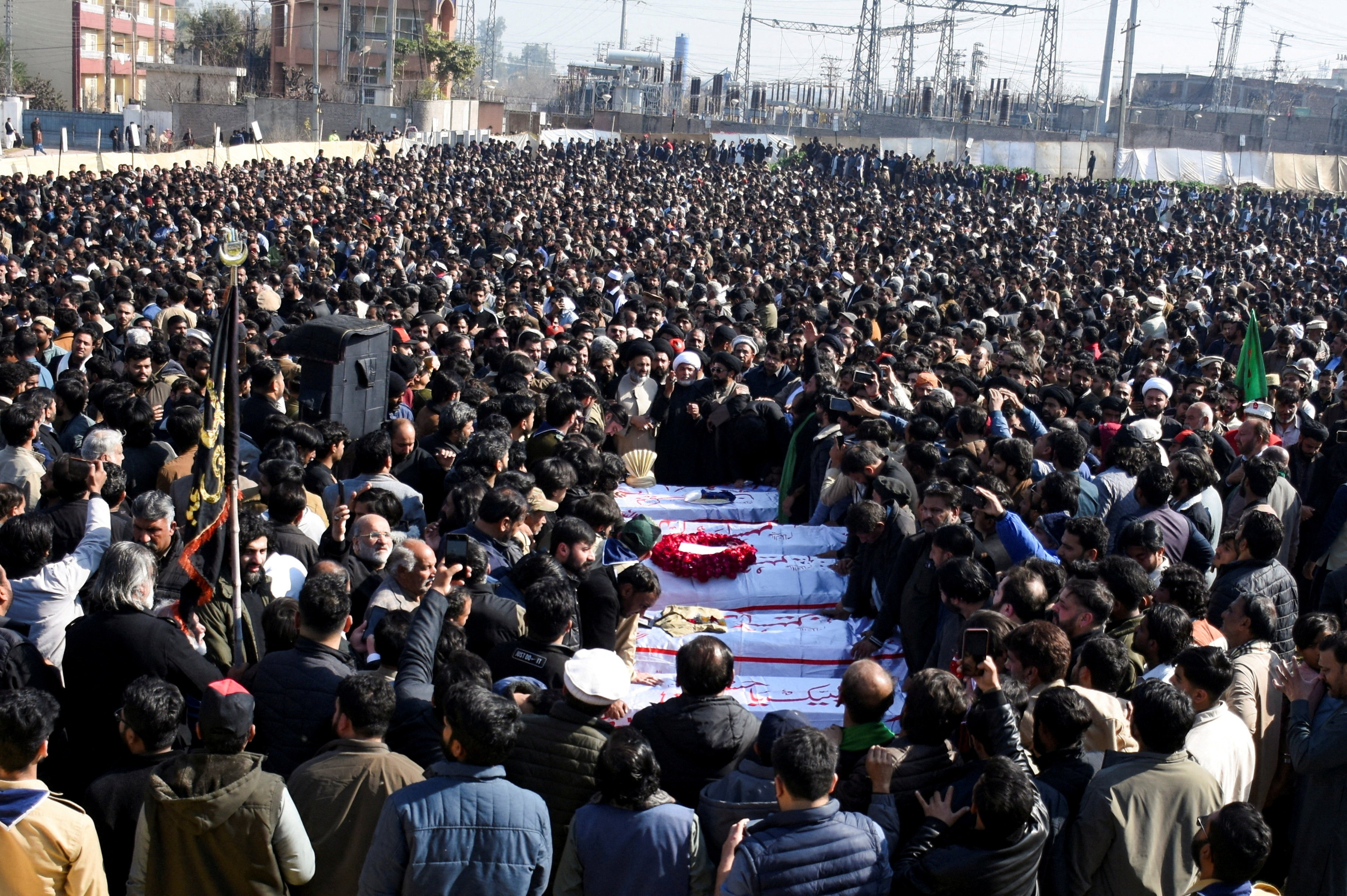 People attend funeral of victims following the suicide explosion at a Shi'ite Muslim mosque, in Islamabad