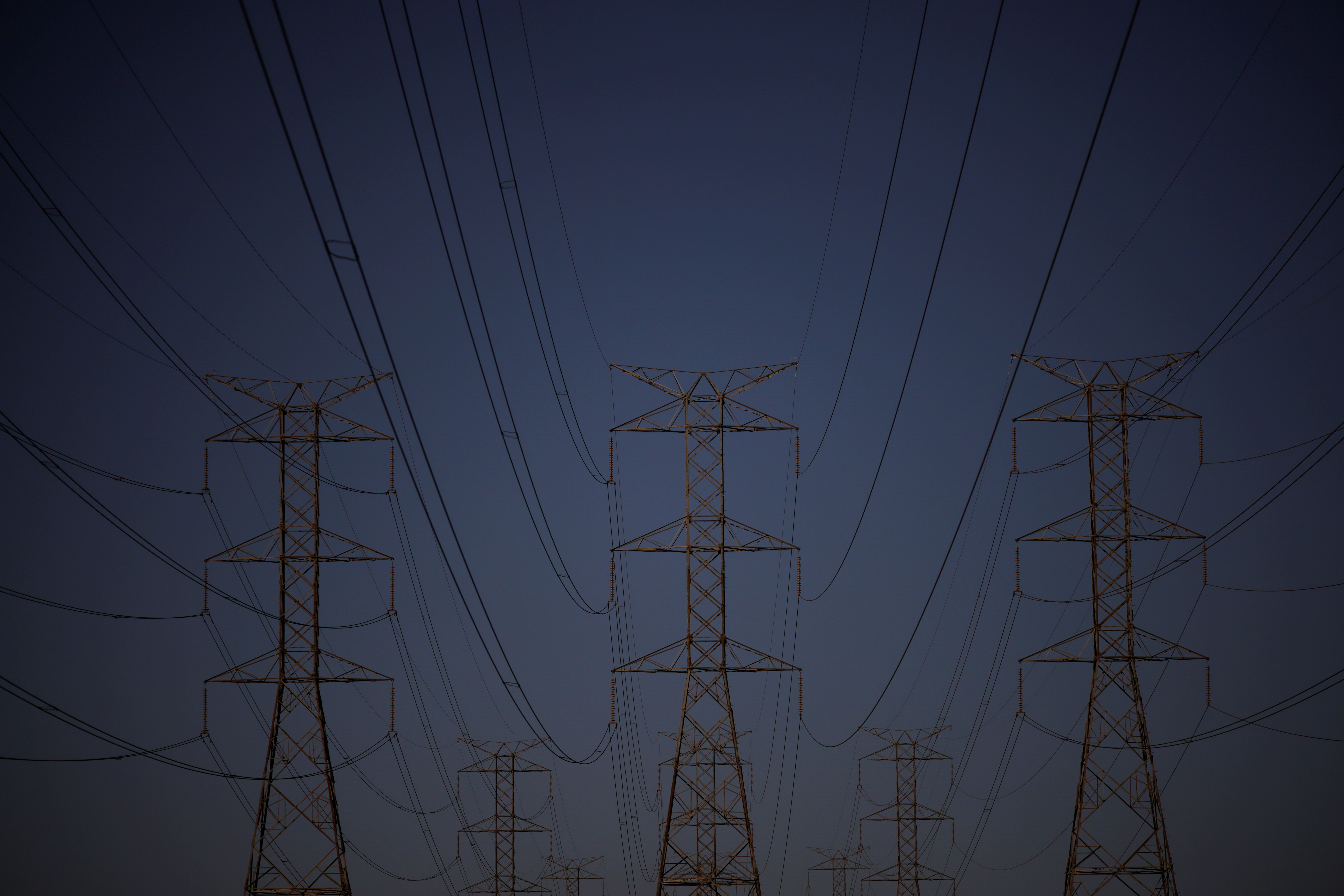 Pylons of high-tension electricity power lines are seen during sunset in Brasilia