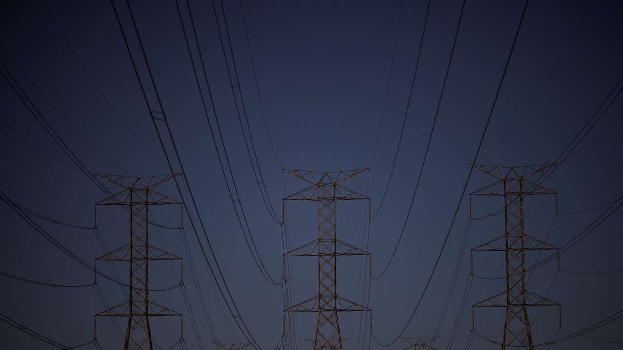 Pylons of high-tension electricity power lines are seen during sunset in Brasilia