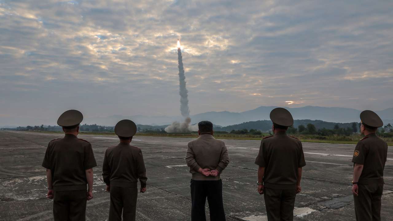 North Korean leader Kim Jong-un looks on during the test of what KCNA described as a new tactical ballistic missile