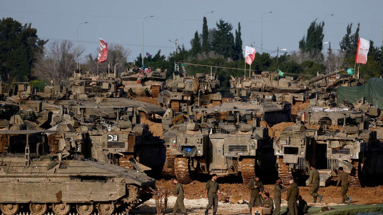 FILE PHOTO: Israeli soldiers work by military vehicles, near the border with Gaza, in Israel