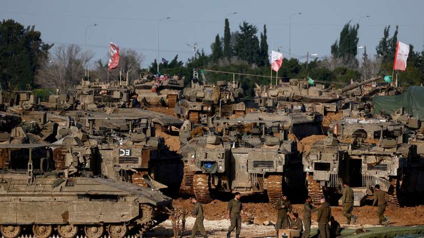 FILE PHOTO: Israeli soldiers work by military vehicles, near the border with Gaza, in Israel