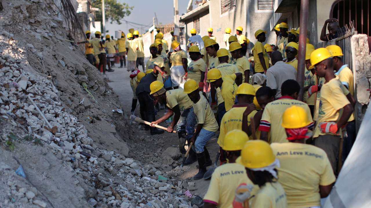 FILE PHOTO: Provisional workers of USAID and DAI remove debris from the January 2010 earthquake in Port-au-Prince