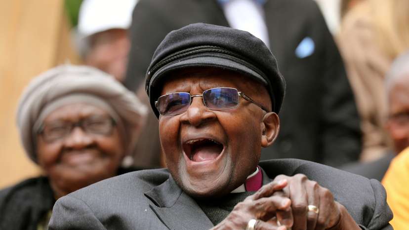 Archbishop Desmond Tutu laughs as crowds gather to celebrate his bithday by unveiling an arch in his hounour outside St Georges Cathedral in Cape Town