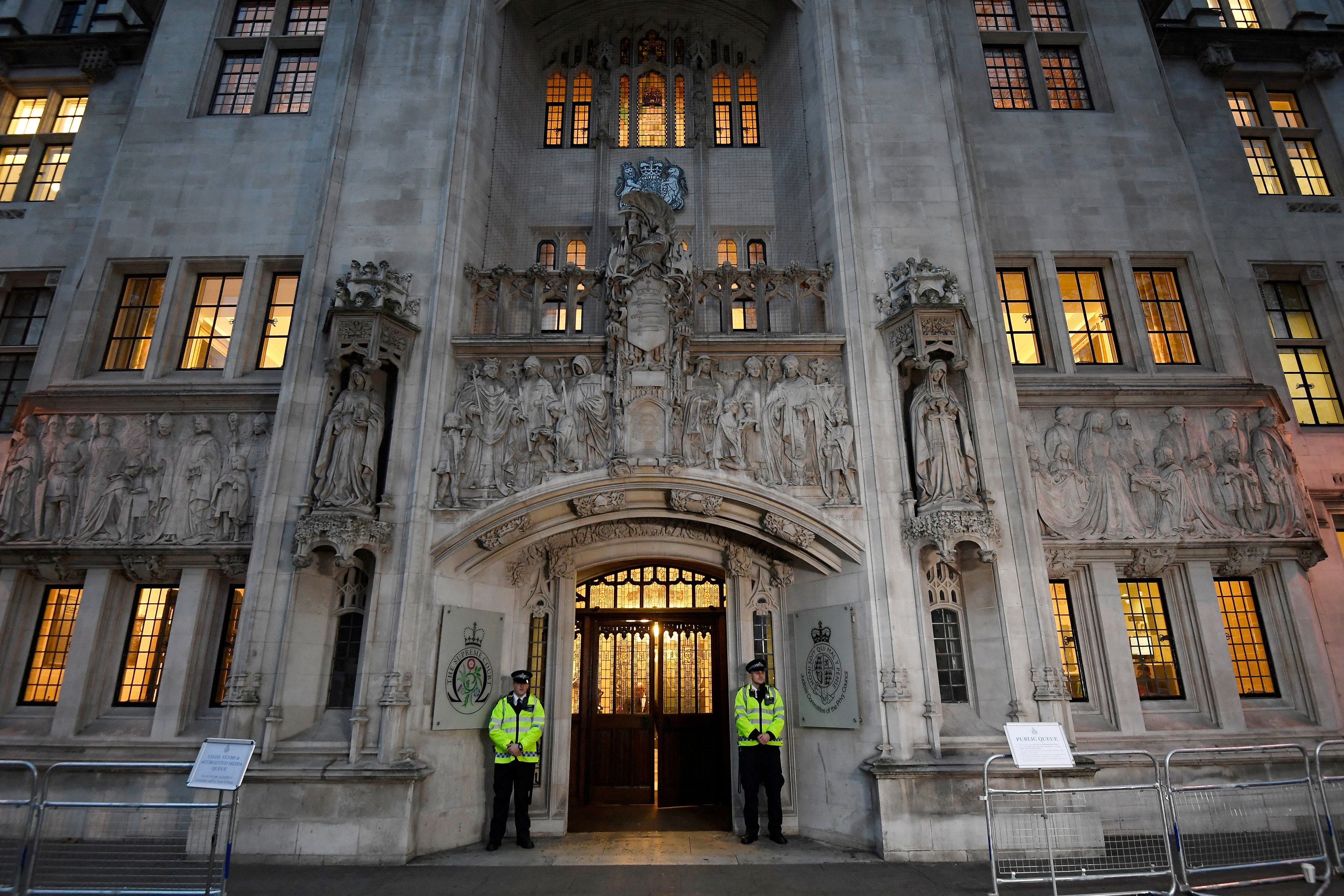 FILE PHOTO: Police officers stand on duty outside the Supreme Court in Parliament Square, central London