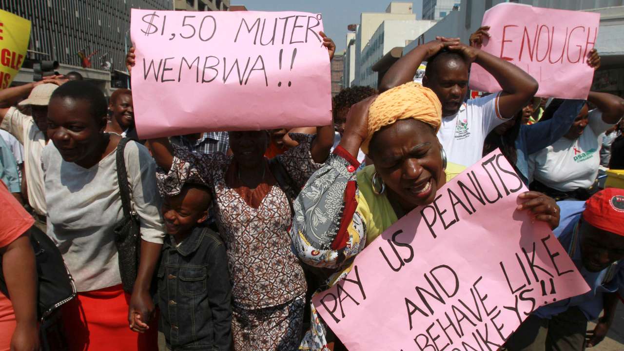 Civil servants and teachers march during a protest for better wages and working conditions in Harare