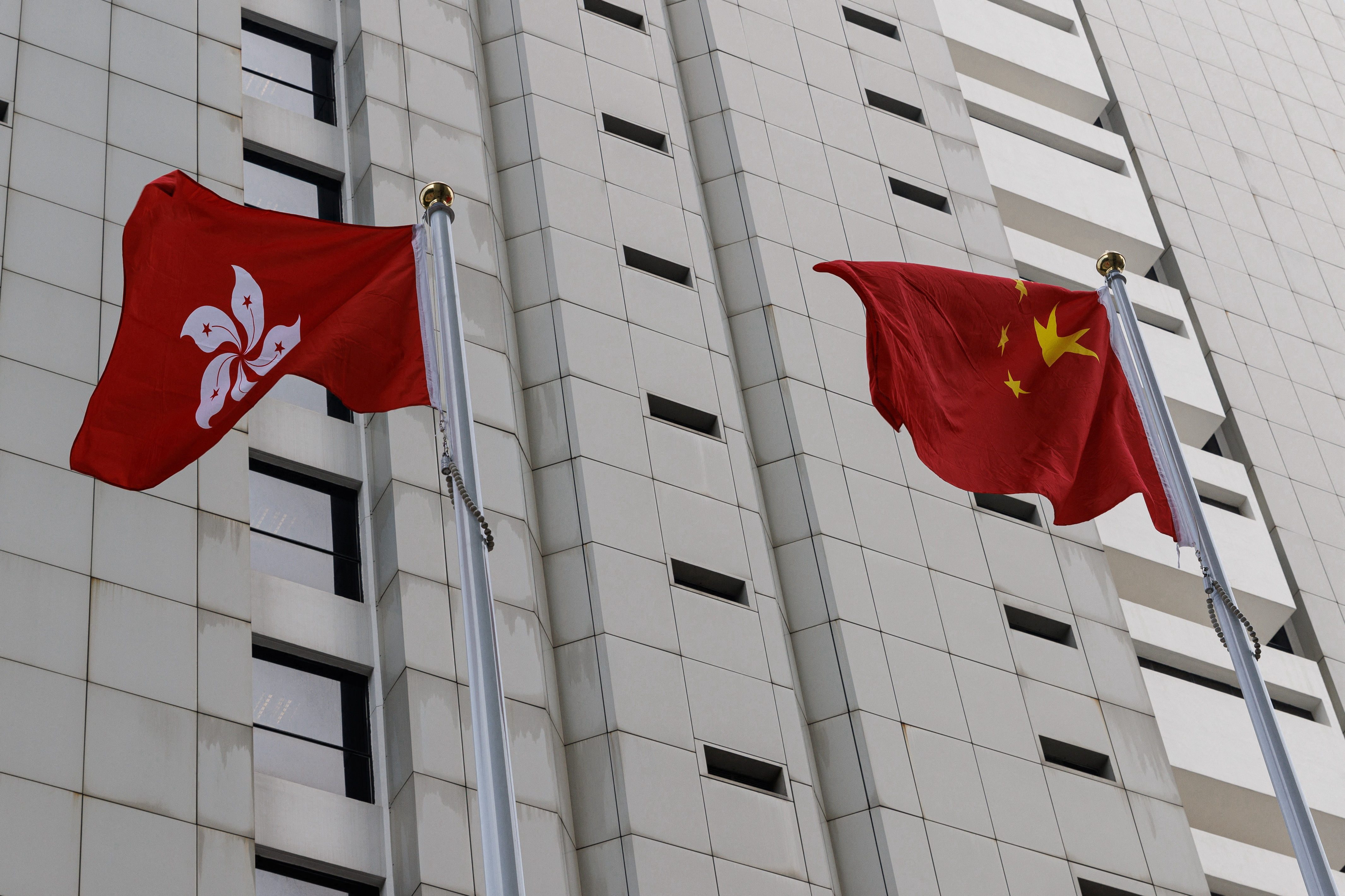 Chinese and Hong Kong flags are seen outside the High Court in Hong Kong