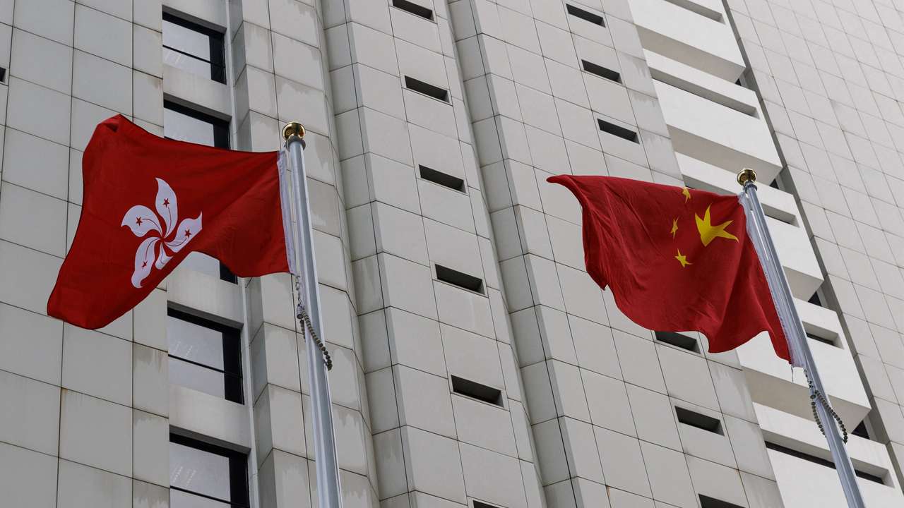 Chinese and Hong Kong flags are seen outside the High Court in Hong Kong