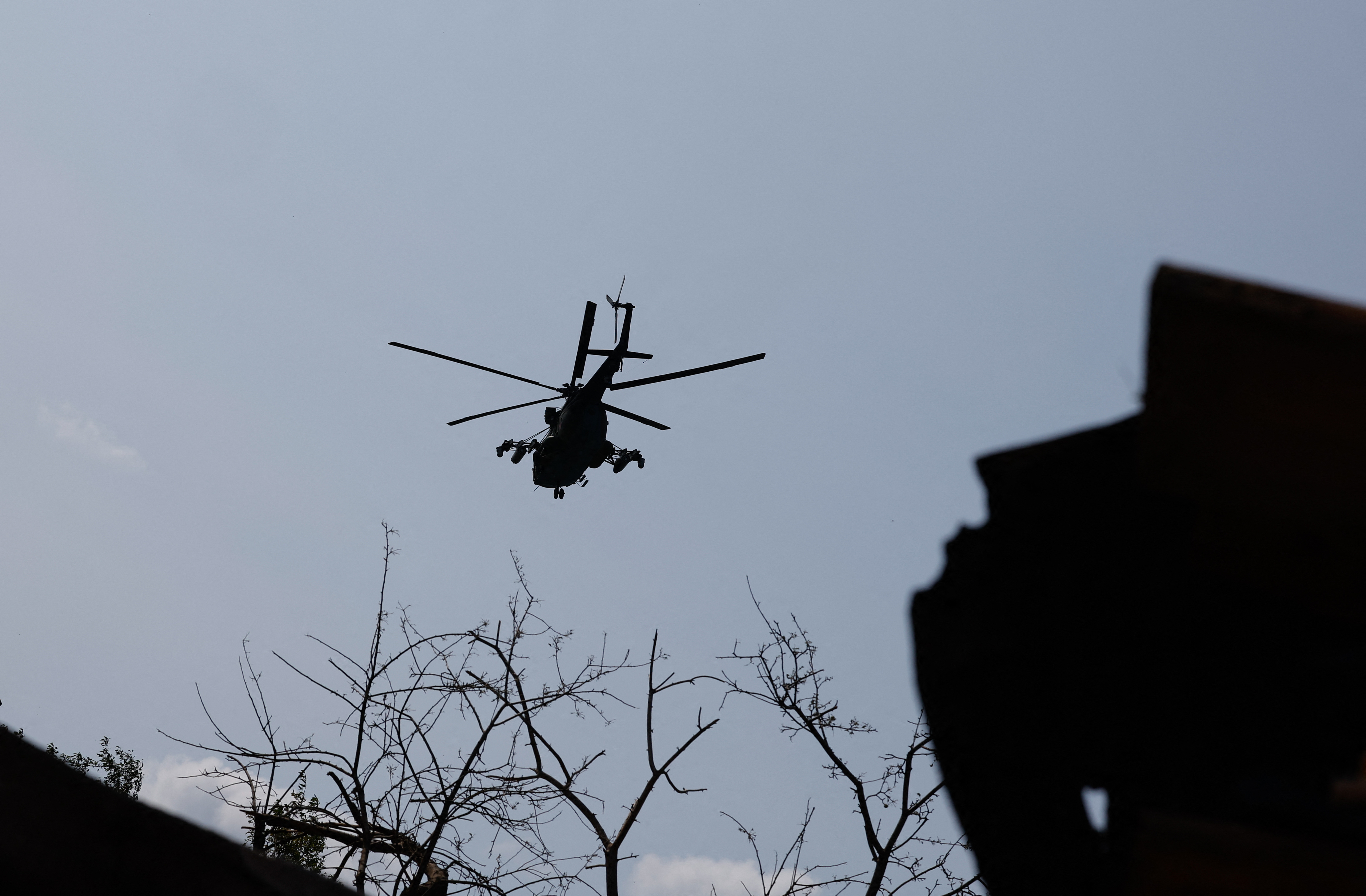 A Russian military helicopter flies in the sky in Donetsk region