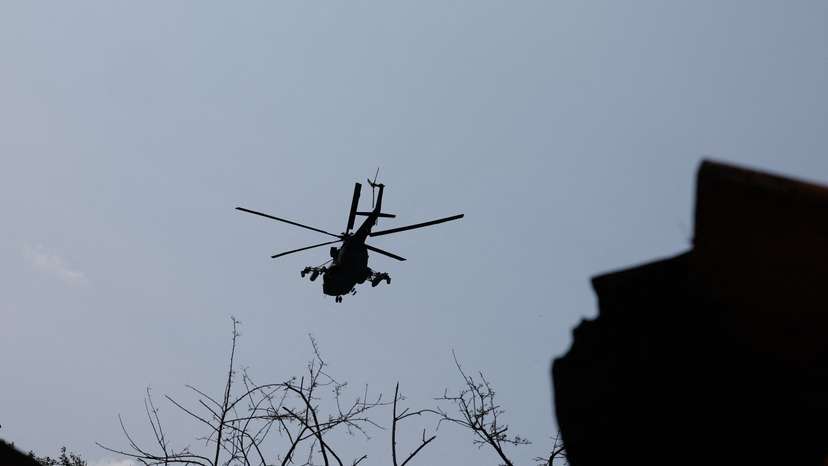 A Russian military helicopter flies in the sky in Donetsk region