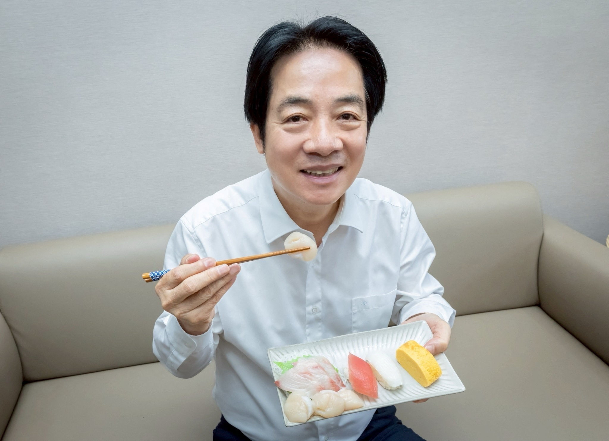 Taiwan President Lai Ching-te shows his sushi lunch of yellowtail and scallops from Japan, in Taipei
