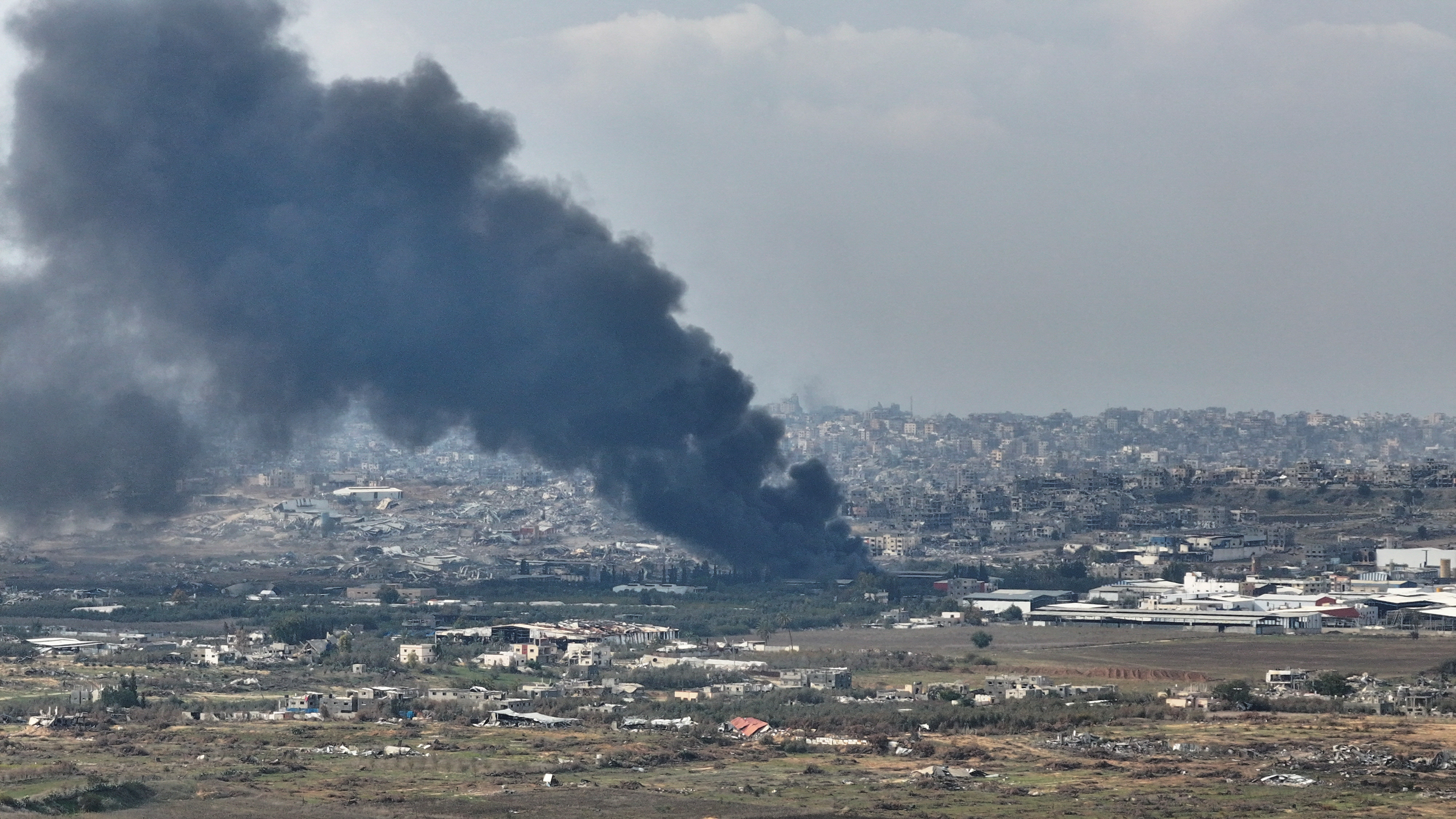 A drone view shows smoke above Beit Hanoun in the Gaza Strip, as seen from near Kibbutz Nir Am in southern Israel
