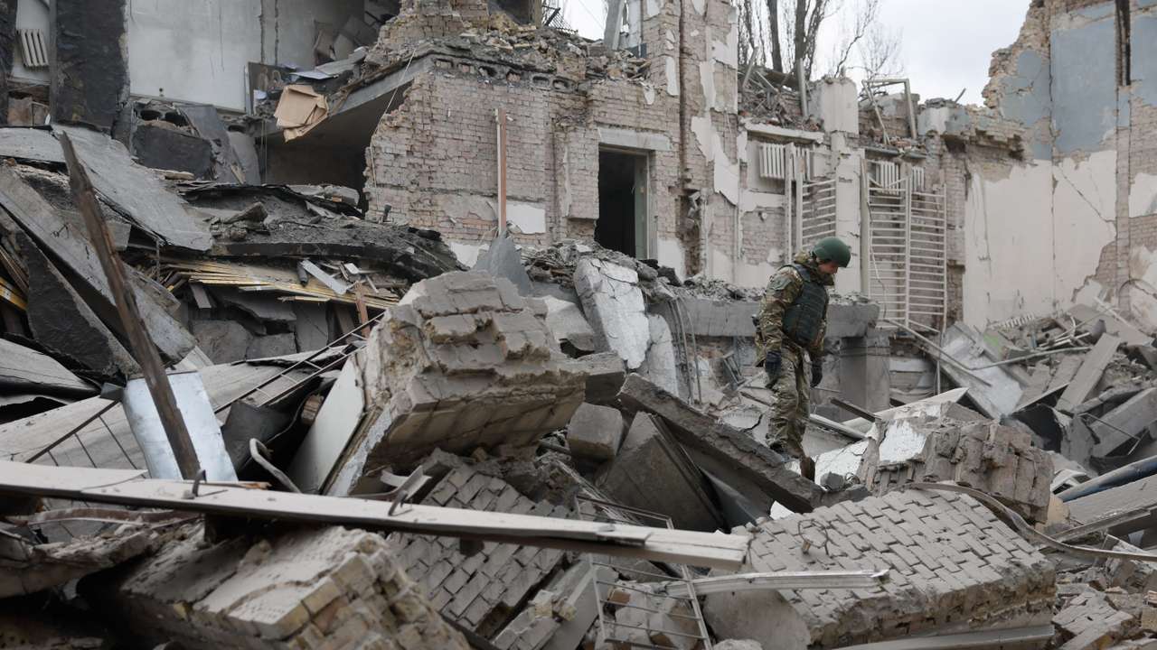 Rescuers work at the site of a building damaged by a Russian missile strike, in Kyiv