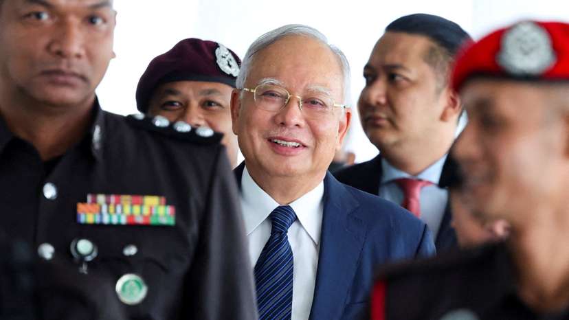 FILE PHOTO: Prison officers escort former Malaysian PM Razak, in Kuala Lumpur