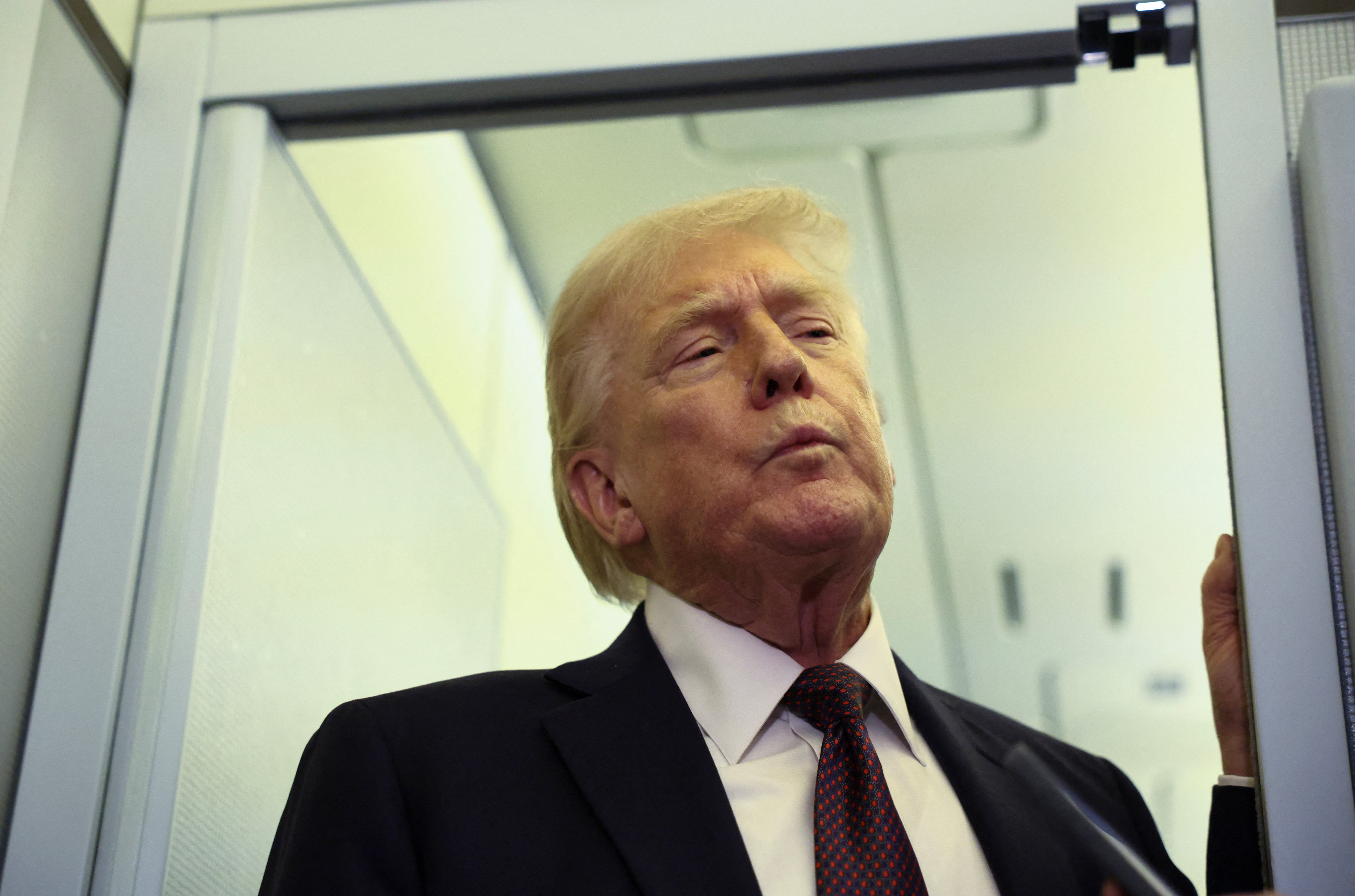 Trump speaks to reporters aboard Air Force One