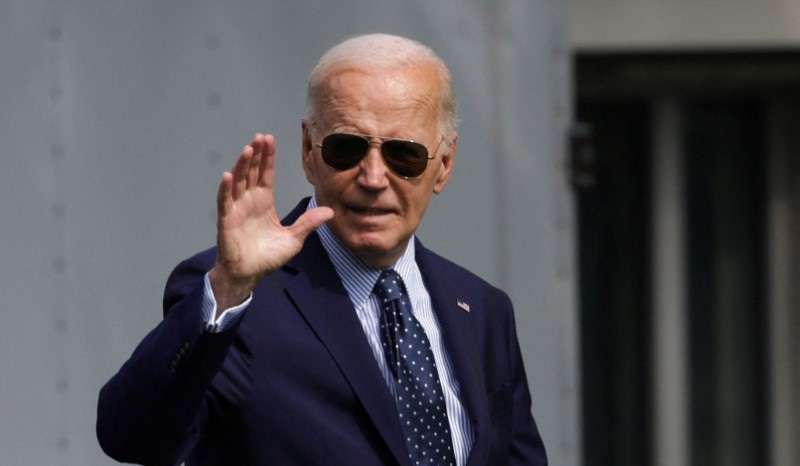 U.S. President Biden waves before boarding Marine One, as he departs the White House in Washington