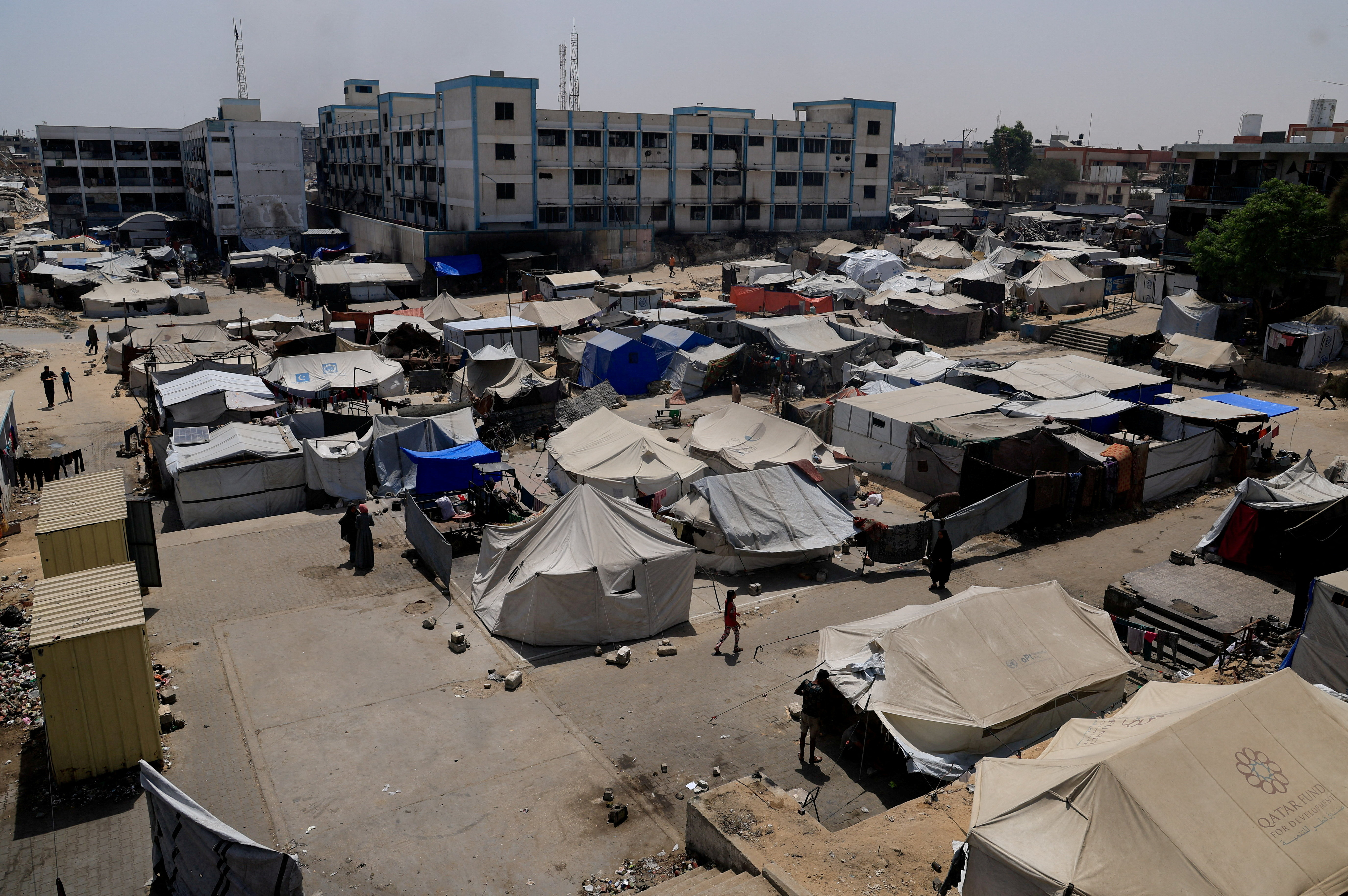 FILE PHOTO: Palestinians displaced by the Israeli military offensive shelter in an UNRWA school, in Khan Younis