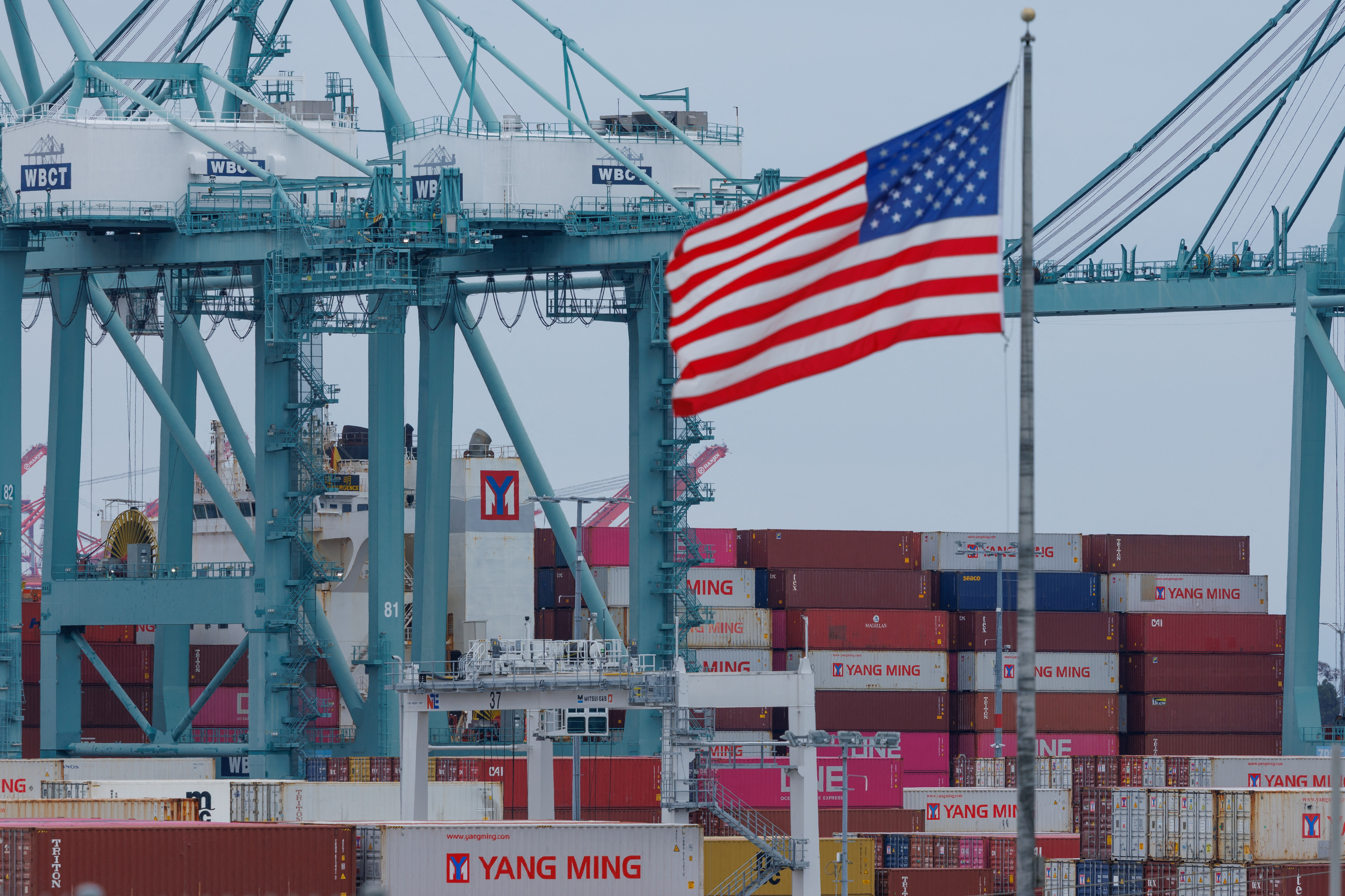 Shipping containers are unloaded at the Port of Los Angeles, in San Pedro