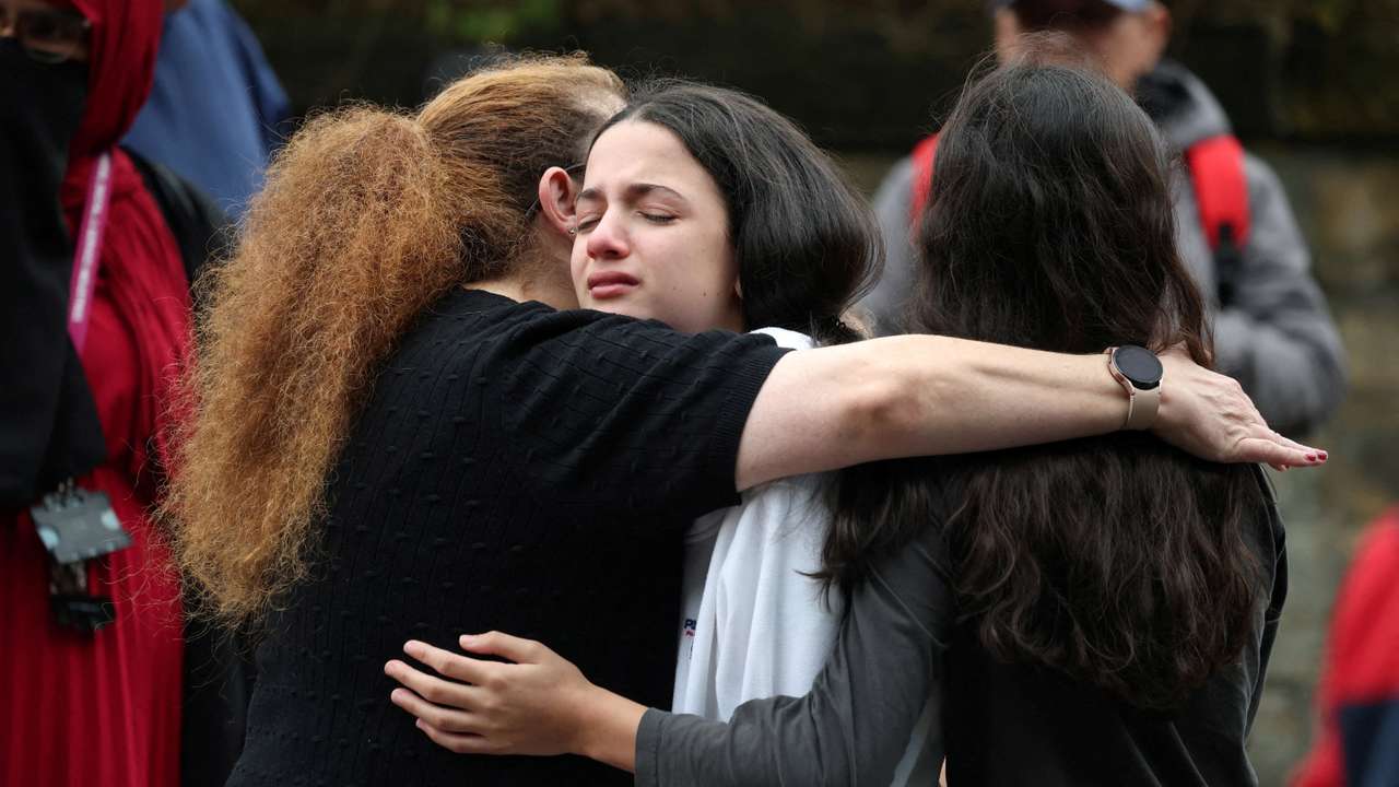 People near the scene following an incident outside a synagogue, in Manchester