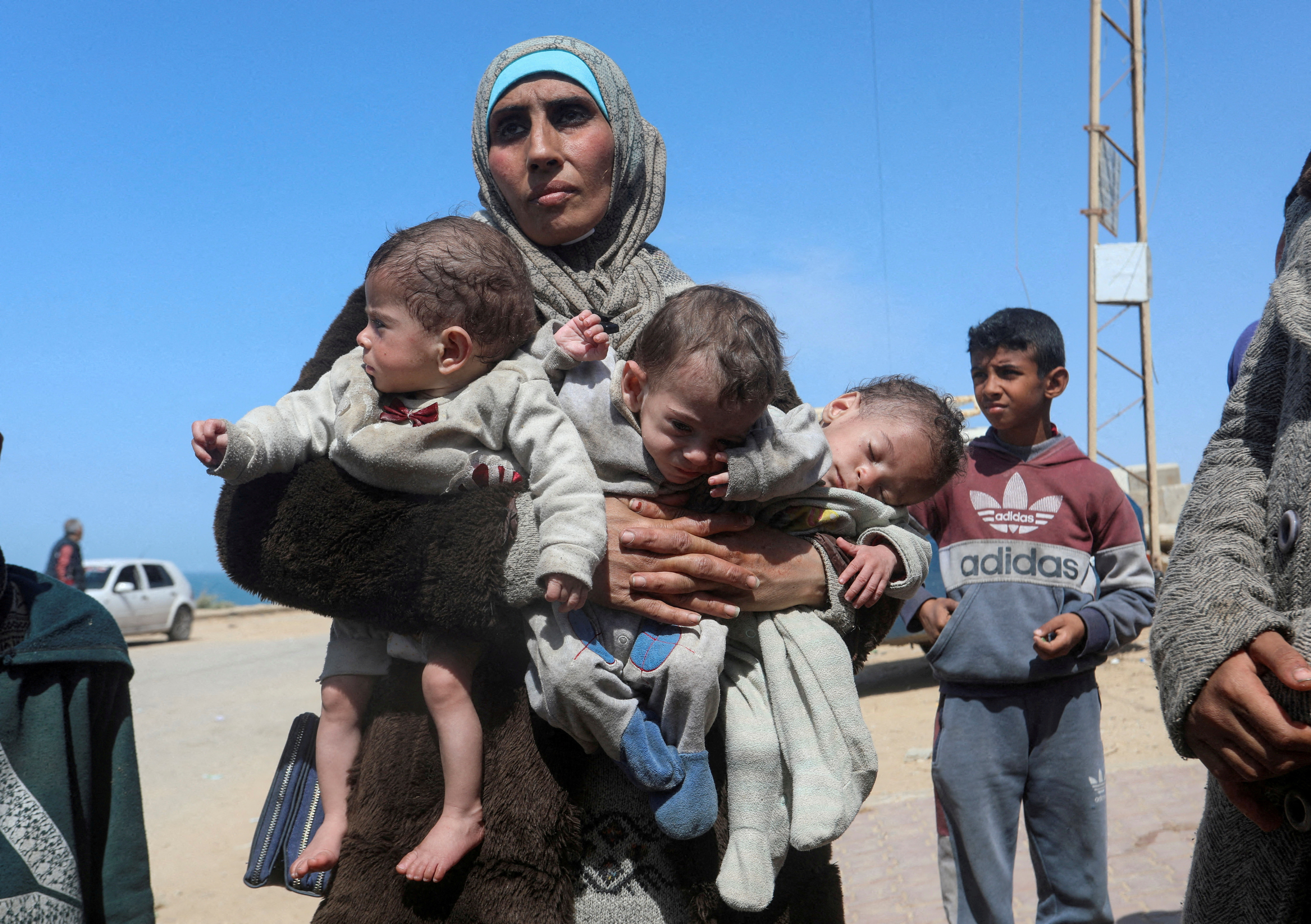 FILE PHOTO: Palestinians fleeing north Gaza after Israeli troops raided Al Shifa hospital, move southward, in the central Gaza Strip
