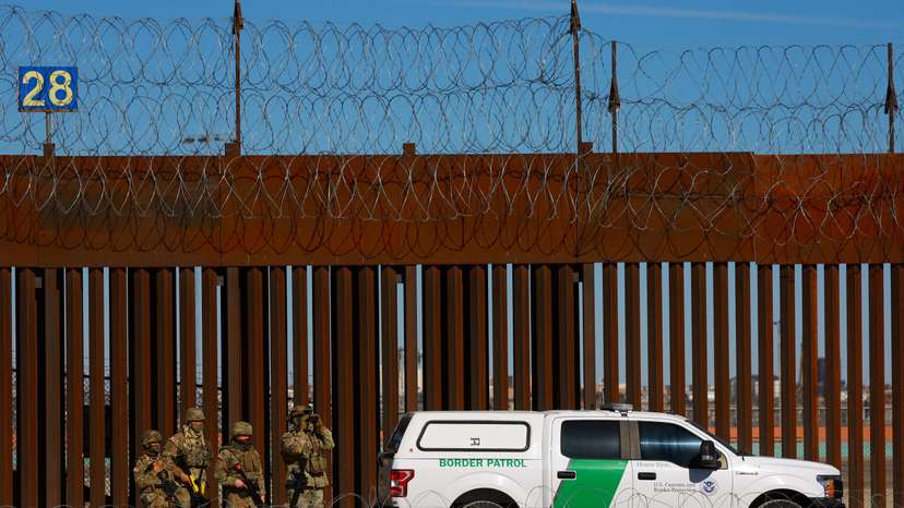 FILE PHOTO: Members of the Texas National Guard stand guard near the border wall between Mexico and the United States