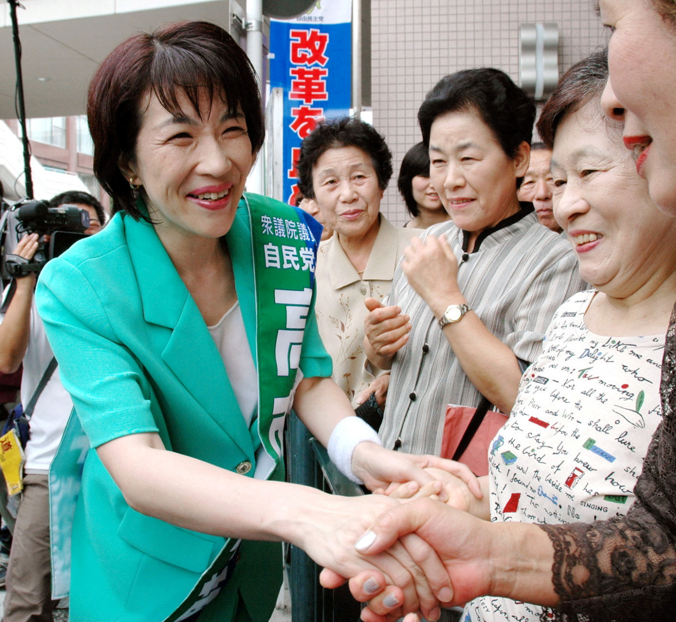 FILE PHOTO: Sanae Takaichi shakes hands with supporters as the official campaign for the lower house elections kicks off, in Ikoma