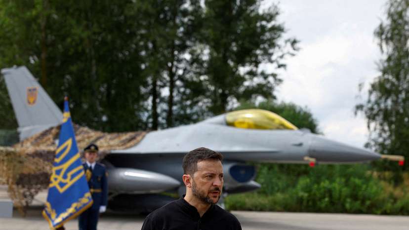 FILE PHOTO: Ukraine's President Zelenskiy speaks to the media in a front of an F-16 fighter jet on the Day of the Ukrainian Air Forces at an undisclosed location in Ukraine