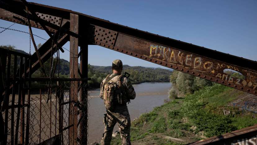 FILE PHOTO: A Ukrainian border guard surveys the border to Romania looking for people who cross illegally including men attempting to flee abroad to avoid military service, in Tyachiv