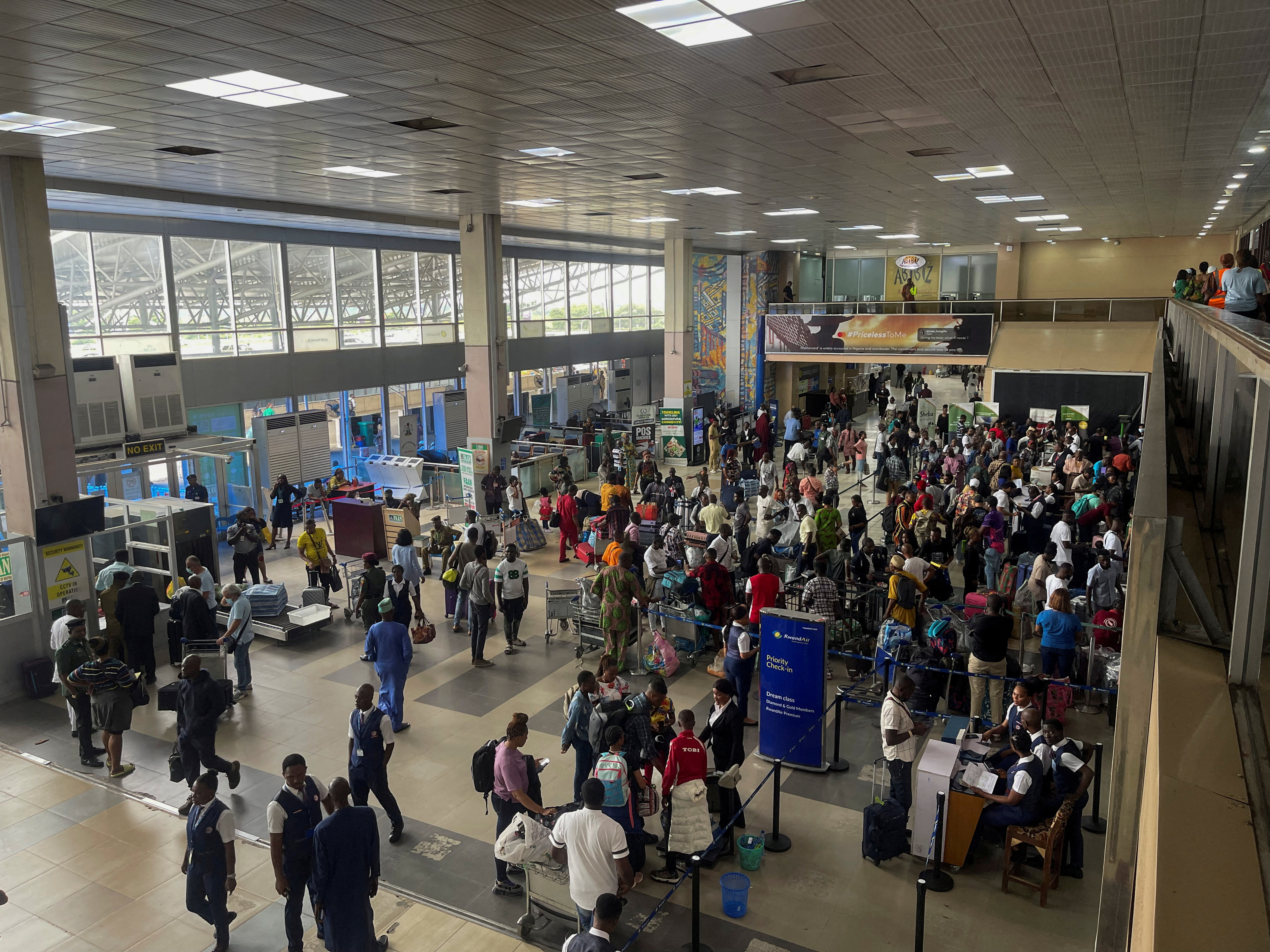 FILE PHOTO: Passengers gather as they check-in their luggages at Murtala Muhammed International Airport in Lagos
