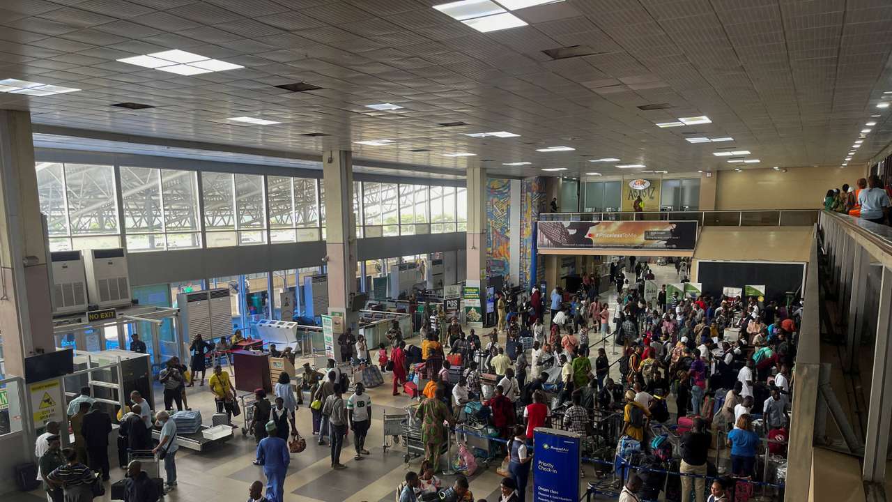 FILE PHOTO: Passengers gather as they check-in their luggages at Murtala Muhammed International Airport in Lagos
