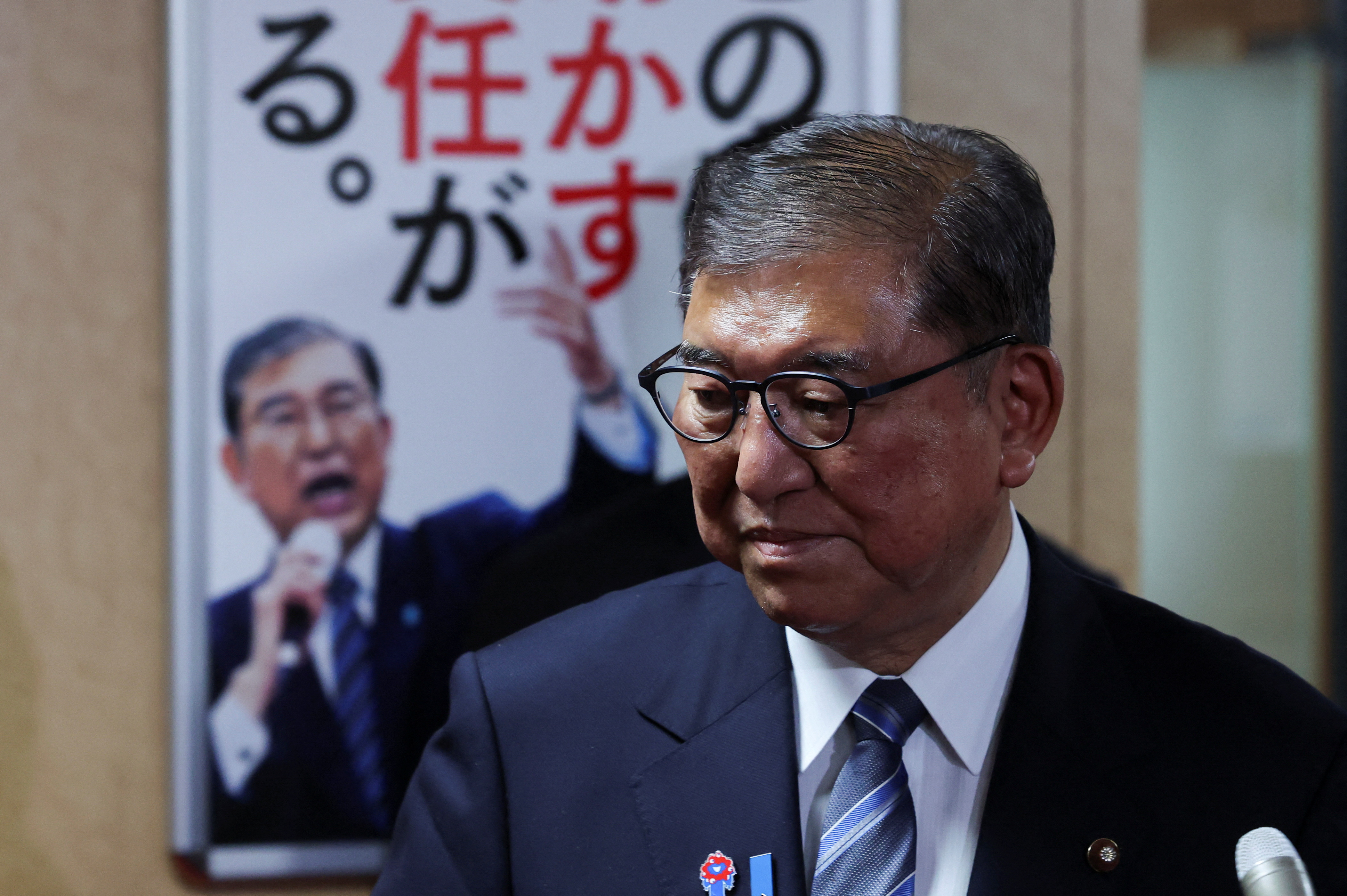 Japan's Prime Minister Ishiba speaks to media after meeting with the party's executives at the LDP headquarters in Tokyo
