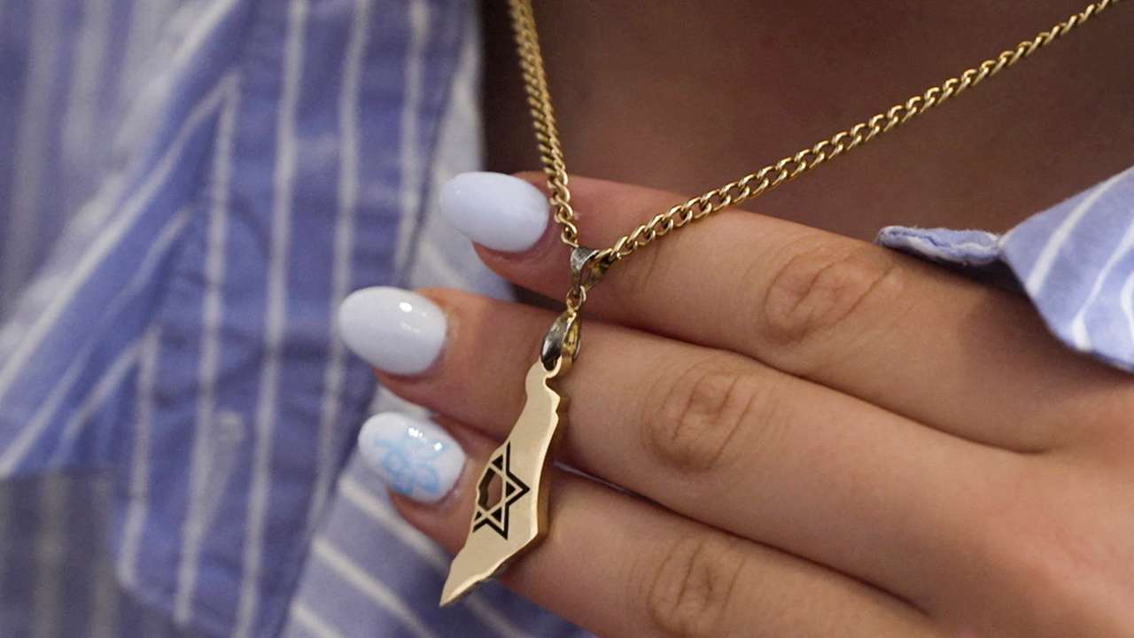14-year-old Bondi shooting survivor, Chaya Dadon, holds a pendant in Sydney