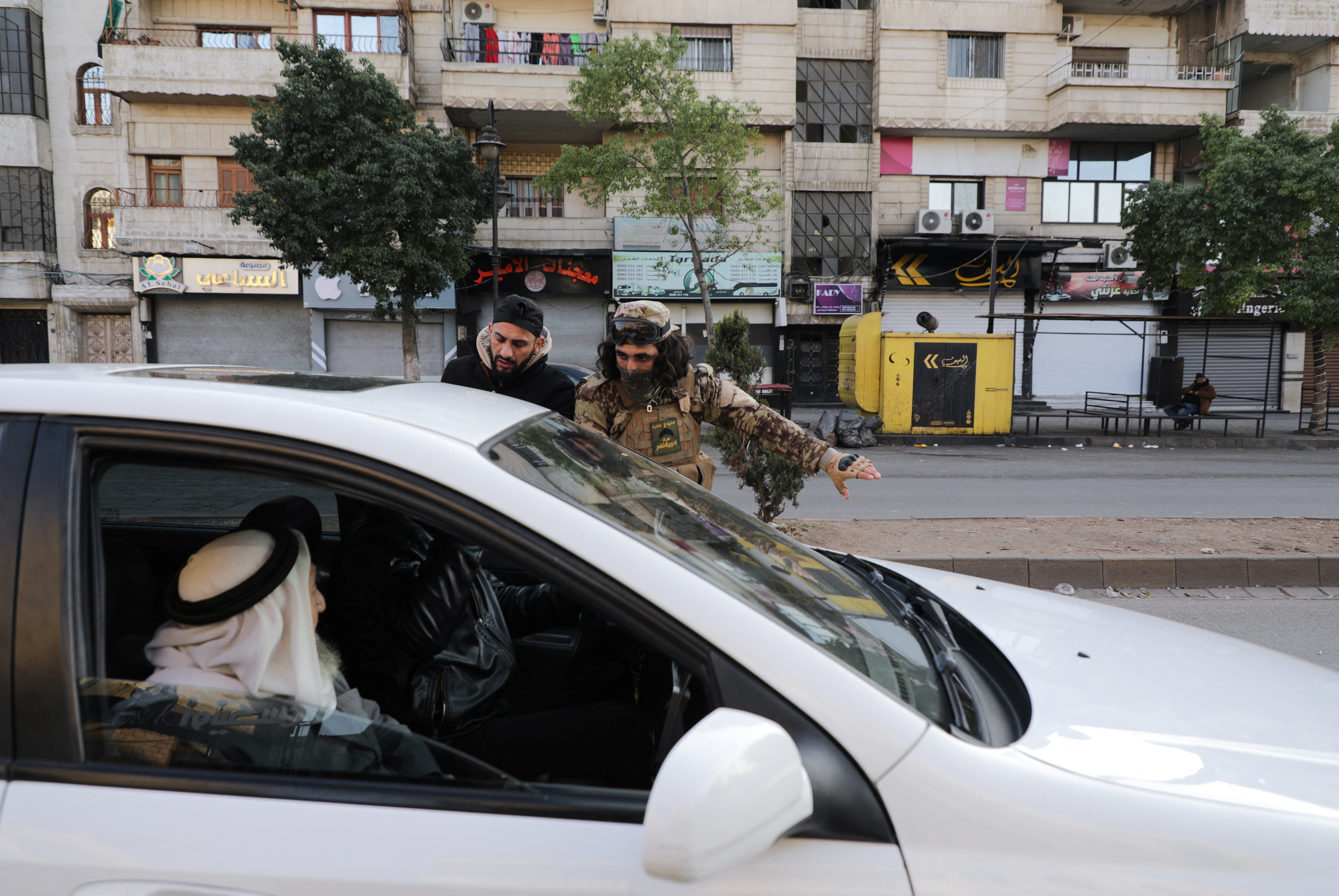Fighters of the ruling Syrian body patrol after dissent surfaced in the city of Homs