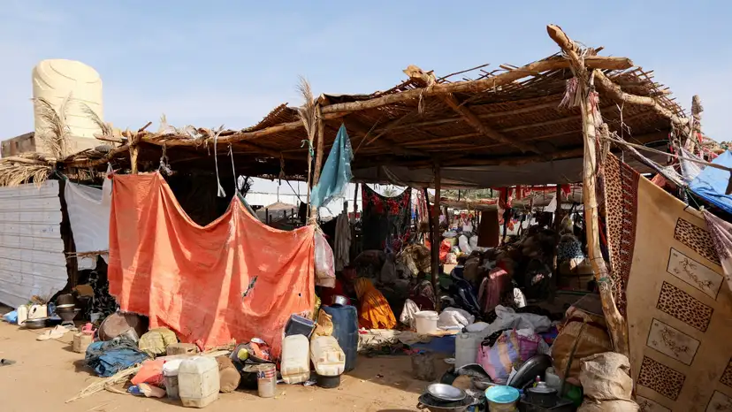 FILE PHOTO: Sudanese women who fled intense fighting in al-Fashir sit on the ground at a displacement camp, in Al Dabba