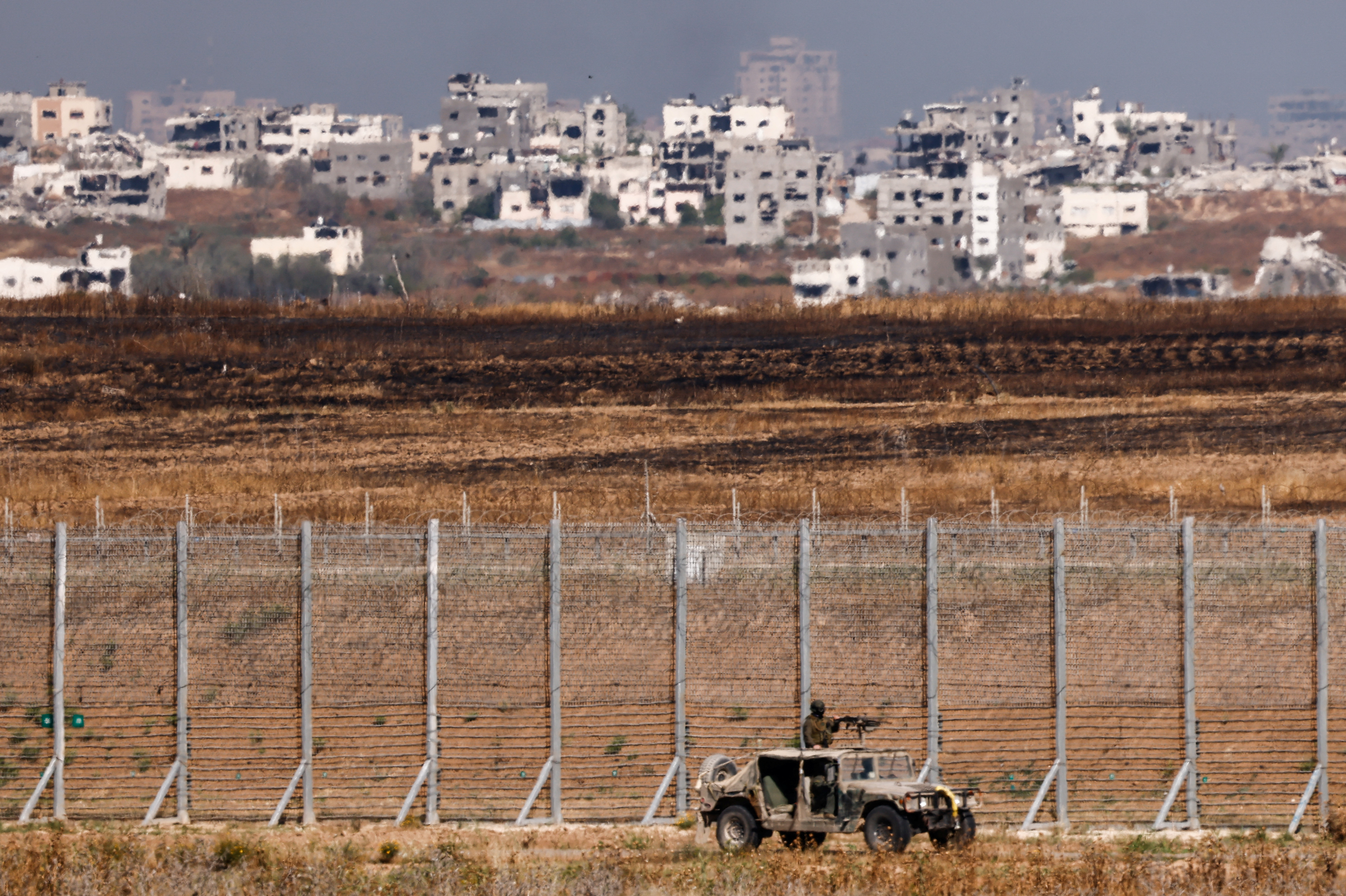 An Israeli military vehicle patrols on the Israeli side of the Gaza border