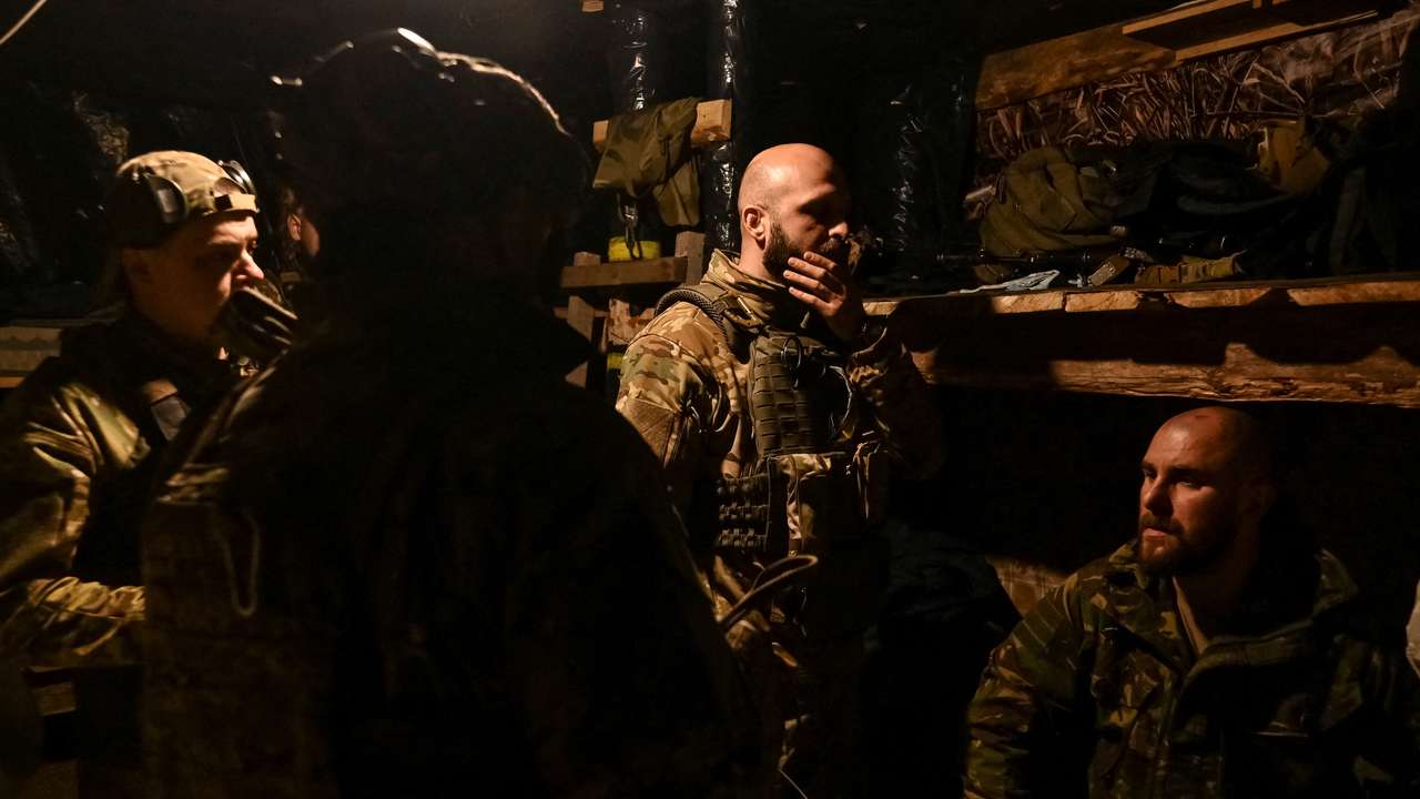 Ukrainian service members from the special police rest in a dugout near the frontline city of Toretsk