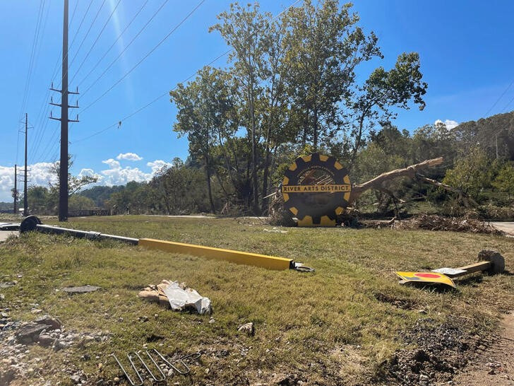 A damaged sign lies on the ground in the River Arts District, after a flash flood triggered by Hurricane Helene, in Asheville, North Carolina,