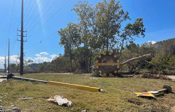 A damaged sign lies on the ground in the River Arts District, after a flash flood triggered by Hurricane Helene, in Asheville, North Carolina,