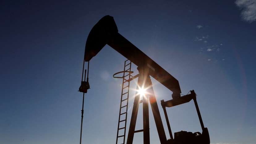 FILE PHOTO: The sun is seen behind a crude oil pump jack in the Permian Basin in Texas
