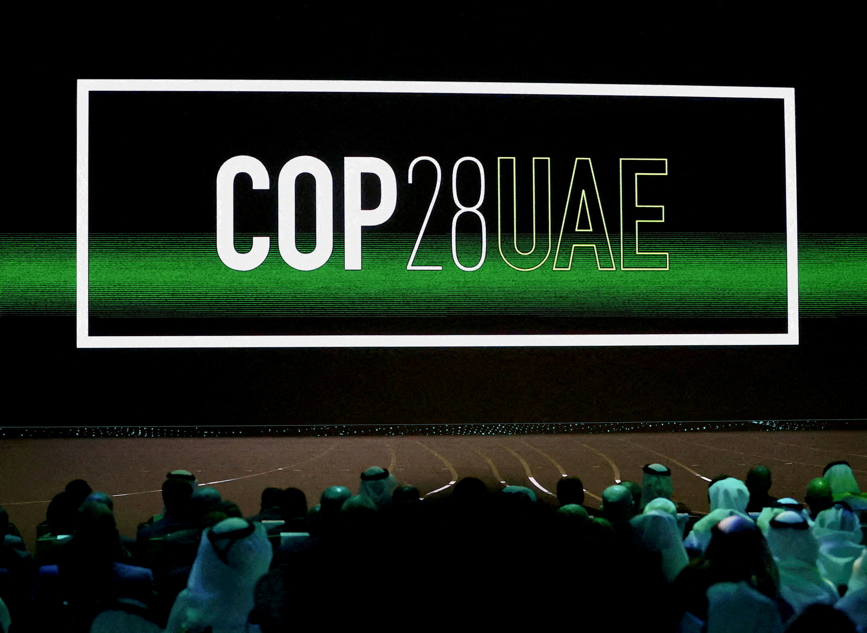 FILE PHOTO: 'Cop28 UAE' logo is displayed on the screen during the opening ceremony of Abu Dhabi Sustainability Week (ADSW) under the theme of 'United on Climate Action Toward COP28', in Abu Dhabi