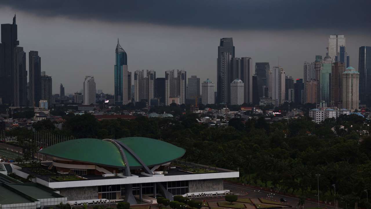 Indonesian Parliament building stands with the skyline in the background in Jakarta