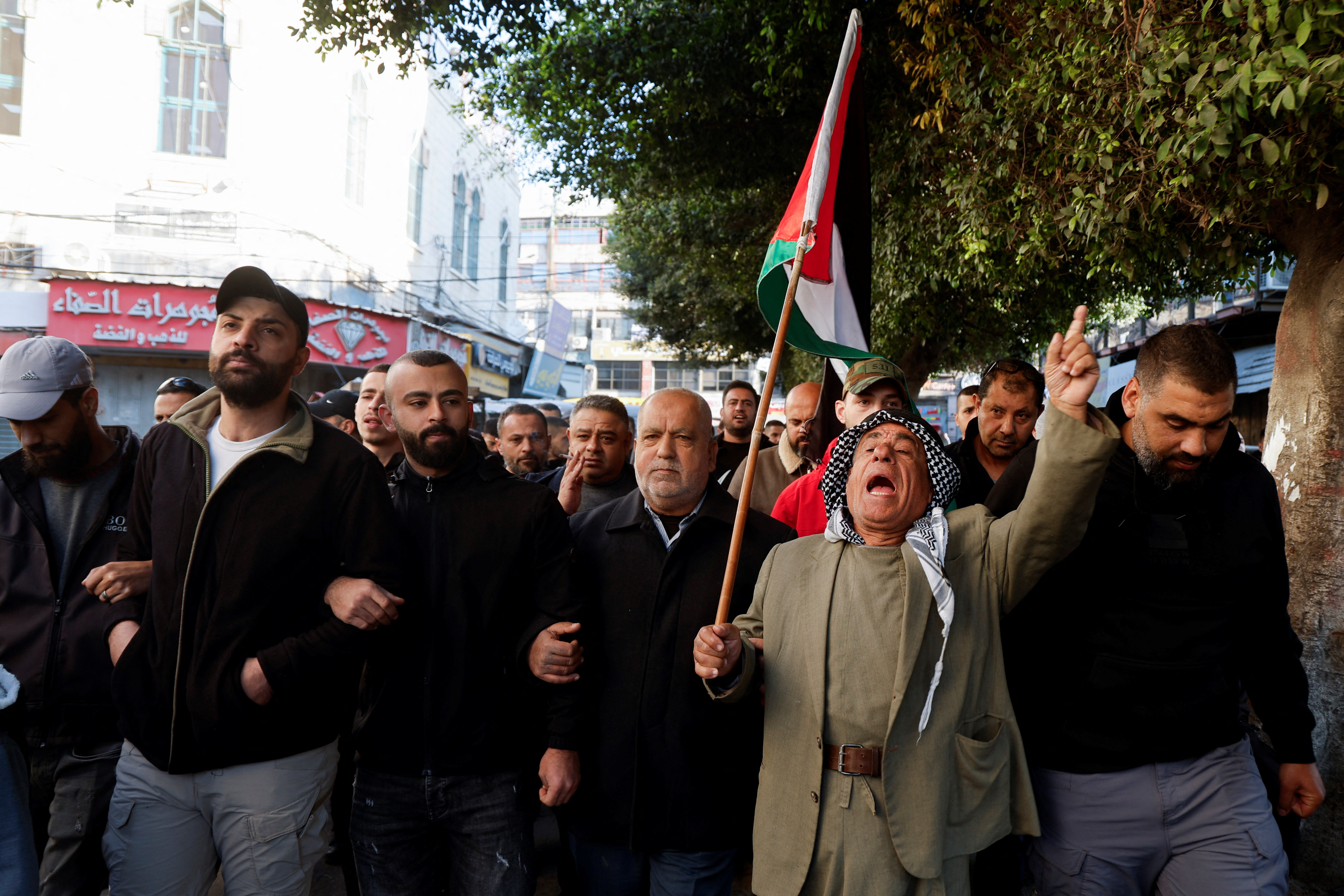 Palestinian demonstrators call for an end to clashes between Palestinian security forces and militants in Jenin
