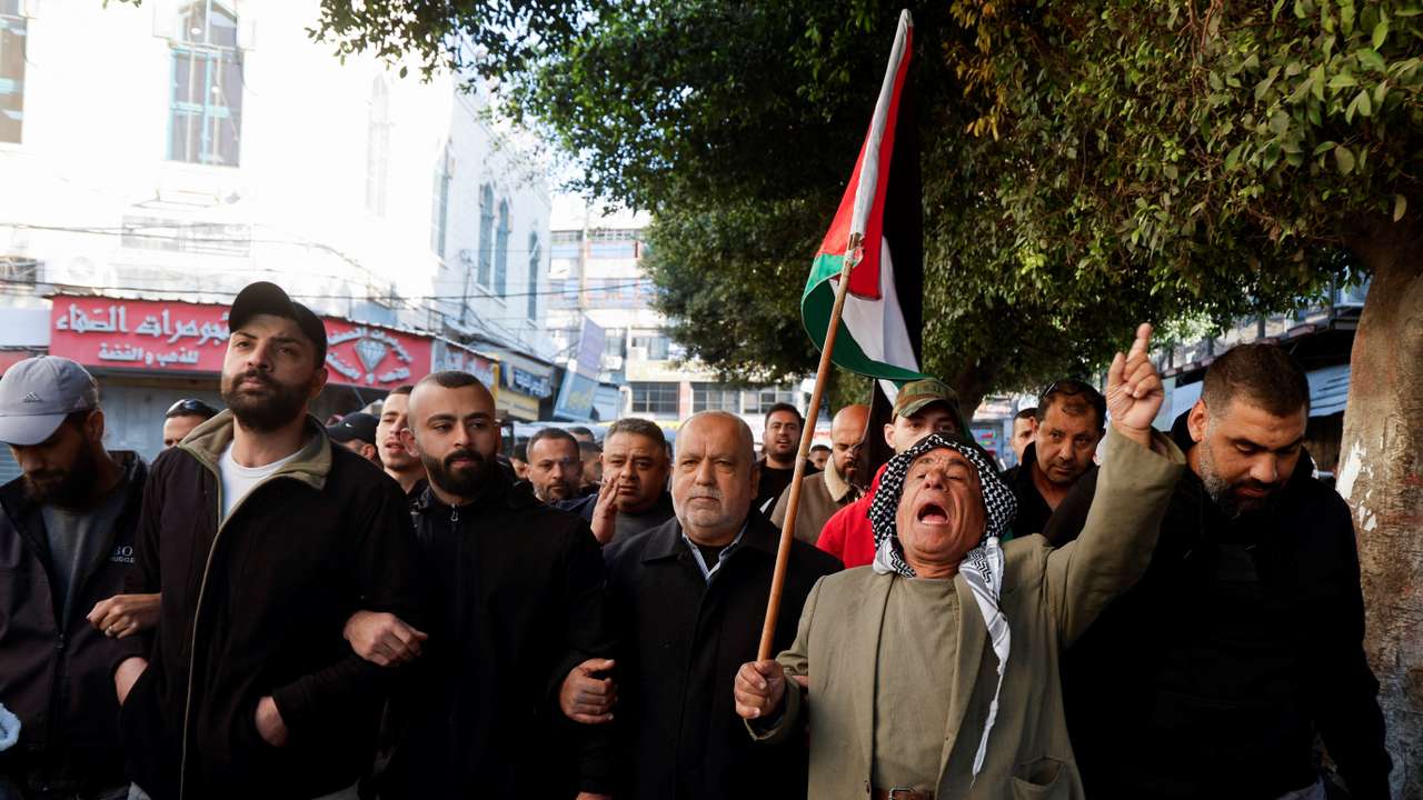 Palestinian demonstrators call for an end to clashes between Palestinian security forces and militants in Jenin