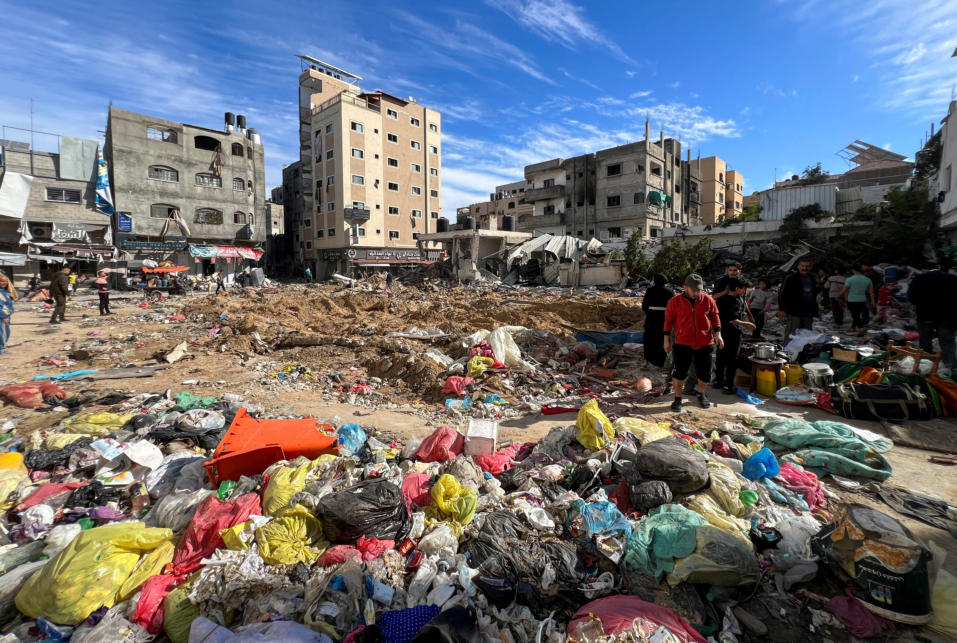 Palestinians inspect damages following an Israeli raid at Kamal Adwan hospital in the northern Gaza Strip