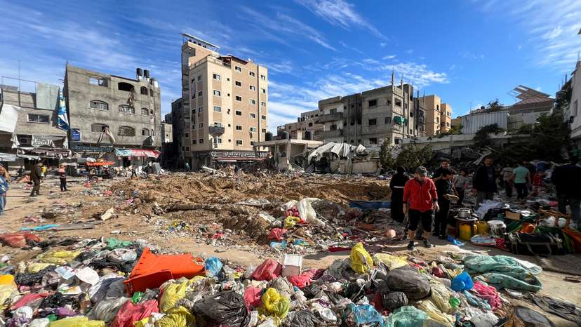 Palestinians inspect damages following an Israeli raid at Kamal Adwan hospital in the northern Gaza Strip