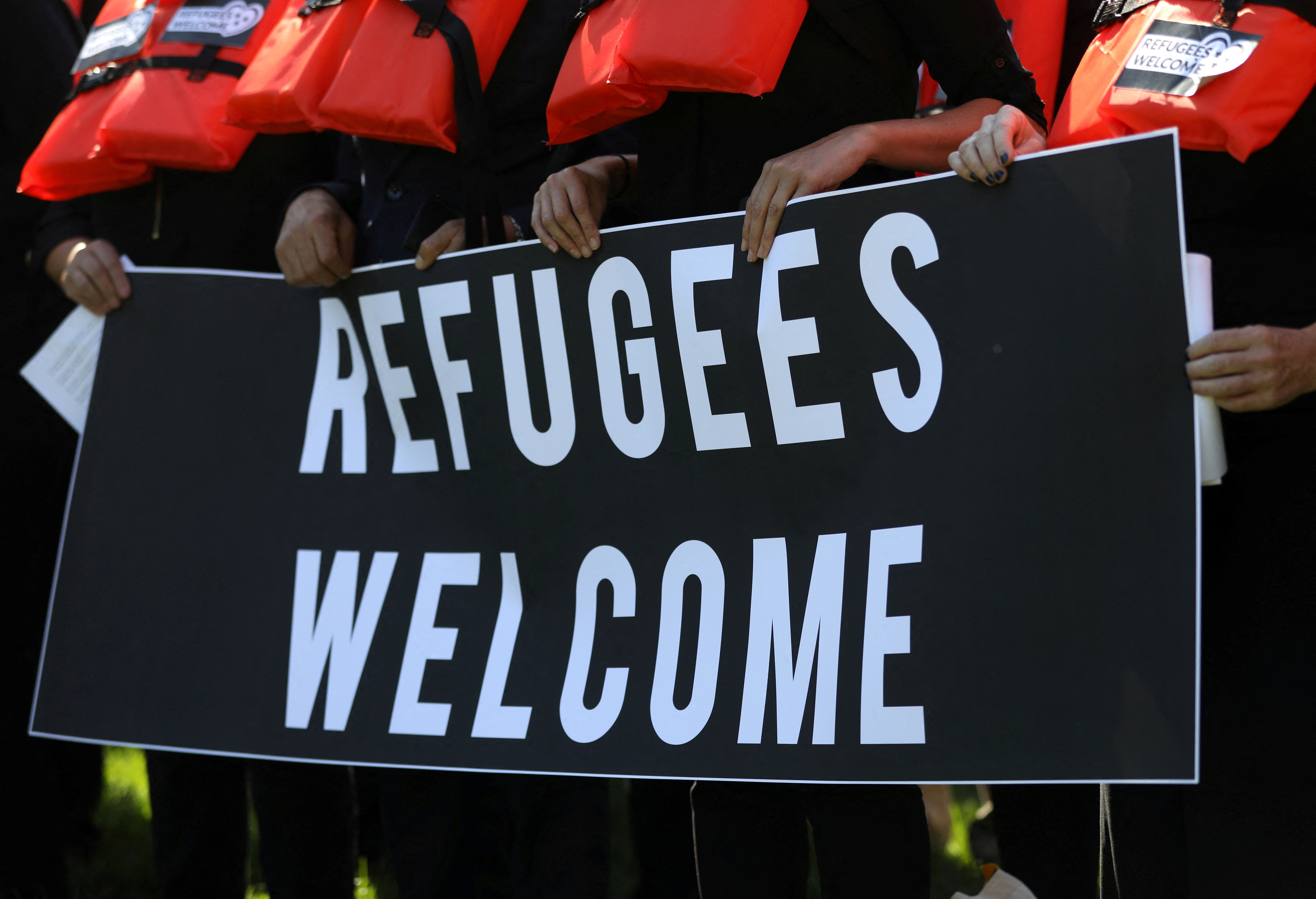 FILE PHOTO: People protest against cuts to the U.S. refugee resettlement program, in Washington