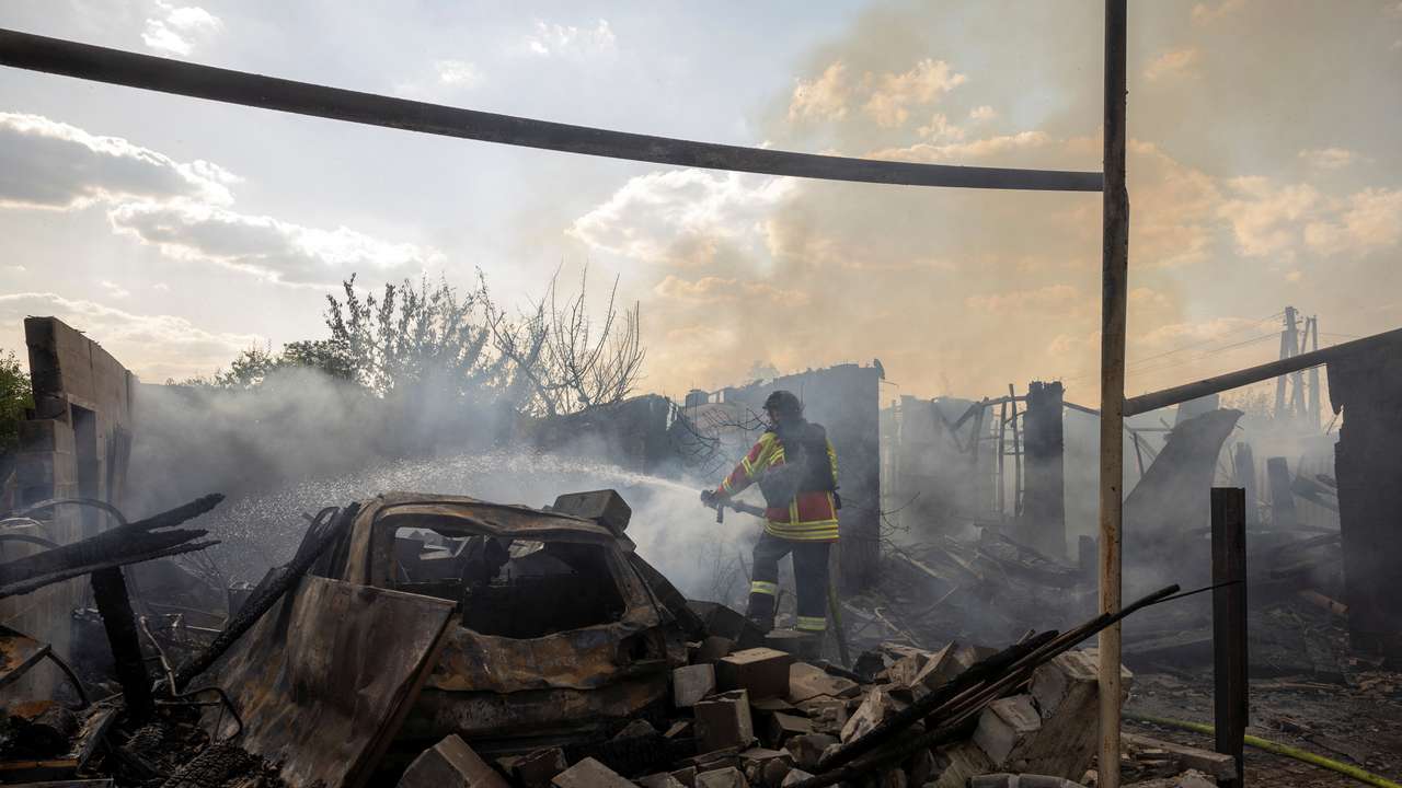 An emergency worker extinguishes a fire that destroyed a private house after a Russian strike on a residential area in Pokrovsk