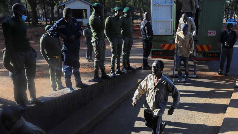 Opposition leader Jameson Timba walks after disembarking a prison truck as he arrives for bail application at the Harare Magistrates' court